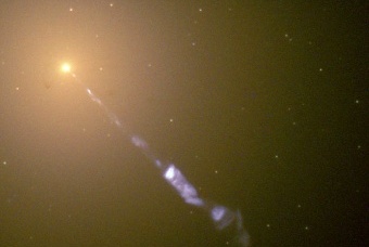 Hubble Space Telescope image of a 5000 light-year long jet being ejected from the active nucleus of the active galaxy M87 (a radio galaxy). The synchrotron radiation of the jet (blue) contrasts with the starlight from the host galaxy (yellow).