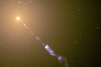 Hubble Space Telescope image of a 5000 light-year long jet being ejected from the active nucleus of the active galaxy M87 (a radio galaxy). The synchrotron radiation of the jet (blue) contrasts with the starlight from the host galaxy (yellow).